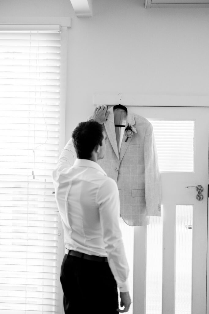 groom getting ready black and white
